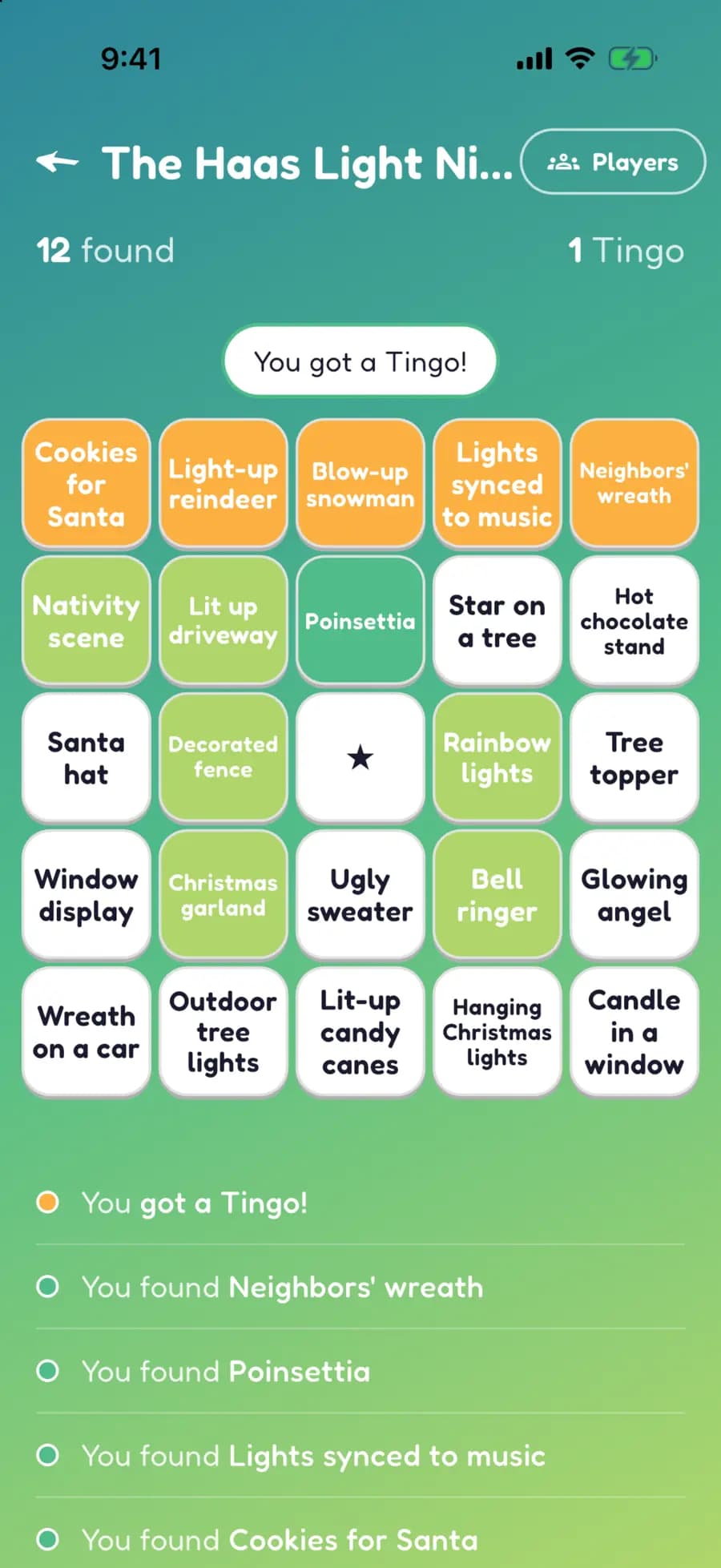 A Let's Tingo board on a phone with Christmas lights finds marked, one row highlighted as a completed Tingo.